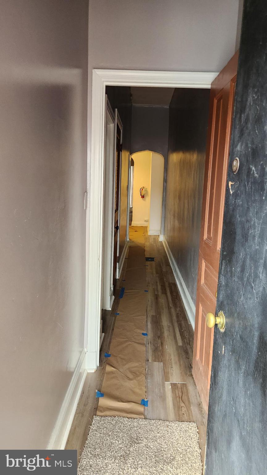 1115 North Calvert Street Baltimore, MD 21202 - Photo 6 of 35 a view of a hallway with wooden floor and staircase