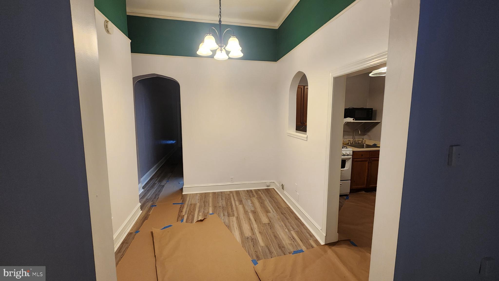 1115 North Calvert Street Baltimore, MD 21202 - Photo 8 of 35 a view of a hallway with wooden floor and staircase