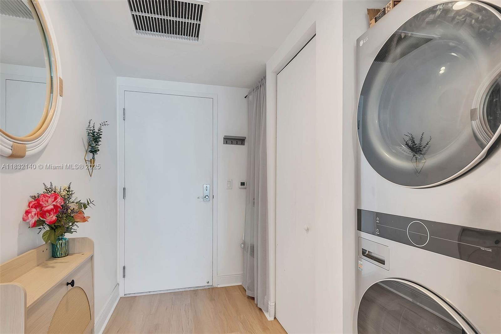 185 Southwest 7th Street, Unit 2204 Miami, FL 33130 - Photo 12 of 21 a view of a hallway with washer and dryer