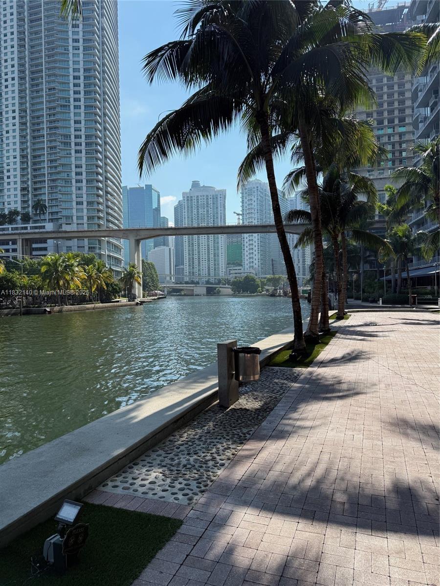 185 Southwest 7th Street, Unit 2204 Miami, FL 33130 - Photo 21 of 21 a view of a lake with a bench and trees