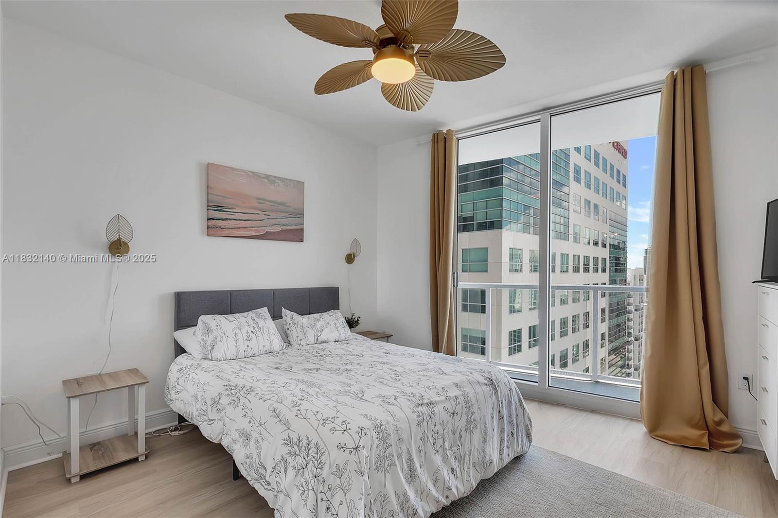 185 Southwest 7th Street, Unit 2204 Miami, FL 33130 - Photo 6 of 21 a bedroom with a large bed and a window