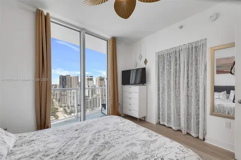 a bedroom with a large bed and a large window