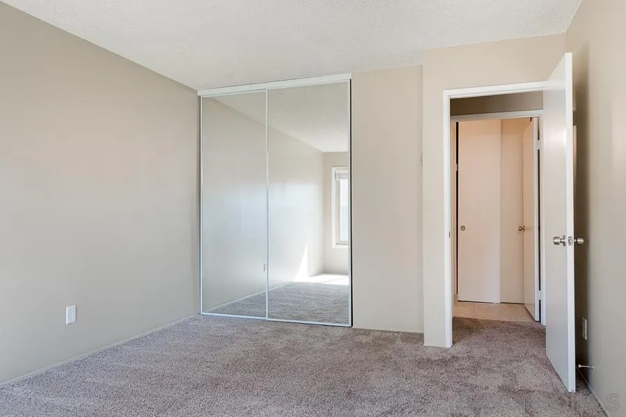 6046 Rancho Mission Road, Unit 384 San Diego, CA 92108 - Photo 11 of 18 an empty room with closet and a bathroom
