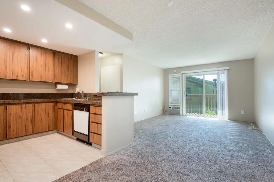 6046 Rancho Mission Road, Unit 384 San Diego, CA 92108 - Photo 2 of 18 a view of a kitchen with a sink and a stove top oven