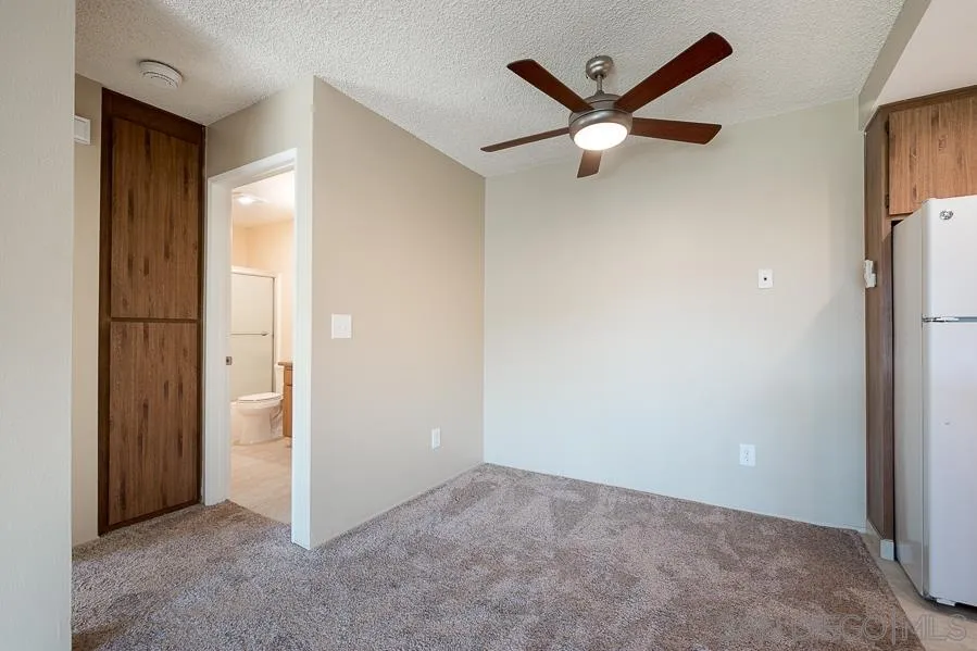 6046 Rancho Mission Road, Unit 384 San Diego, CA 92108 - Photo 9 of 18 an empty room with closet and a ceiling fan