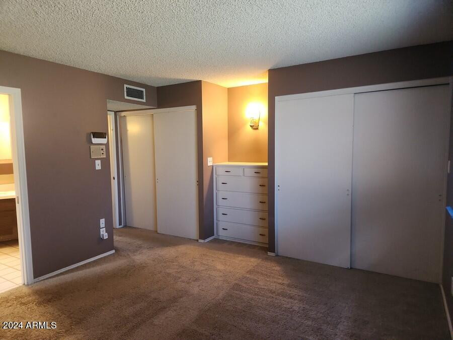 4330 West Royal Palm Road Glendale, AZ 85302 - Photo 16 of 21 an empty room with closet and mirror
