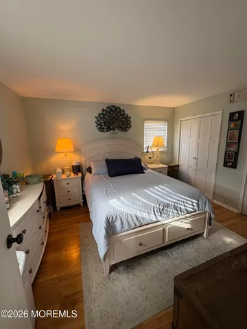 a view of a room with wooden floor and cabinet
