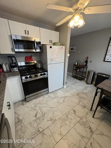 a view of a kitchen with a table and a window