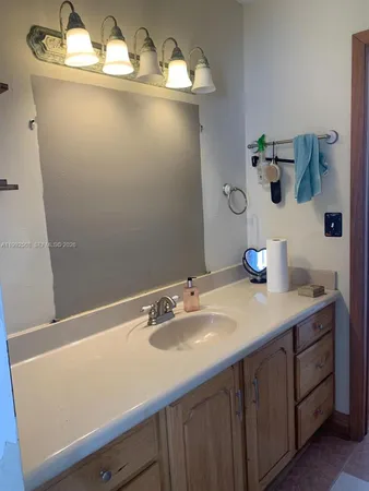 a bathroom with a sink and a mirror