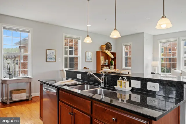 a kitchen with counter top space and windows