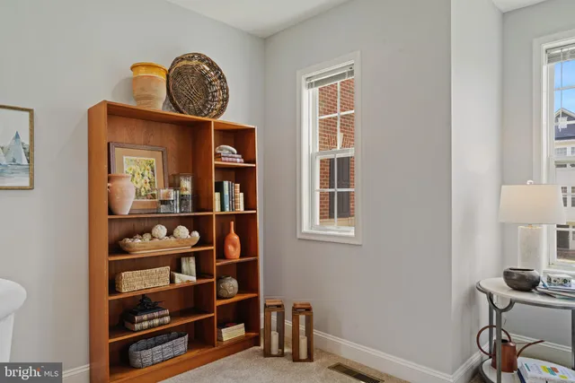 a view of room with workspace and wooden floor