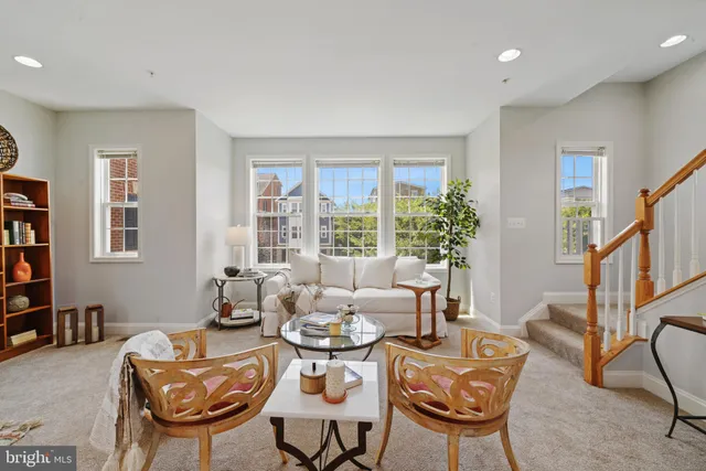 a living room with fireplace furniture and a potted plant