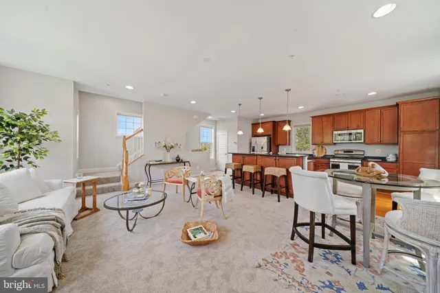 a living room with lots of furniture and kitchen view