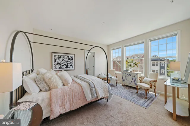 a spacious bedroom with a bed couch and a large window