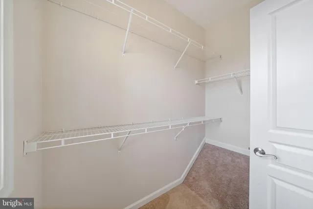 a spacious bathroom with a granite countertop sink toilet a mirror a vanity and shower