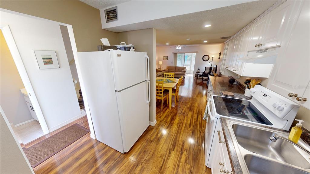 22375 Edgewater Drive, Unit 147 Punta Gorda, FL 33980 - Photo 9 of 31 a view of a kitchen with furniture and wooden floor