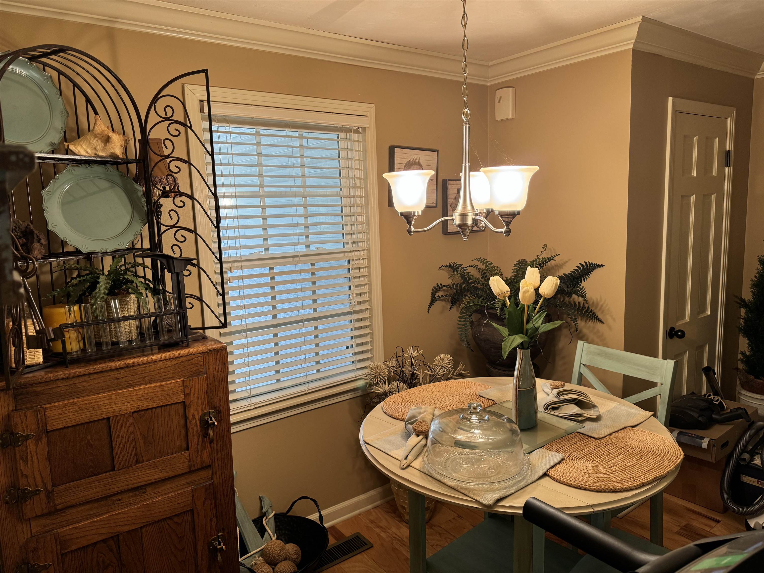 347 Oakgrove Road Selmer, TN 38375 - Photo 15 of 27 Dining room with crown molding, a chandelier, and hardwood / wood-style flooring