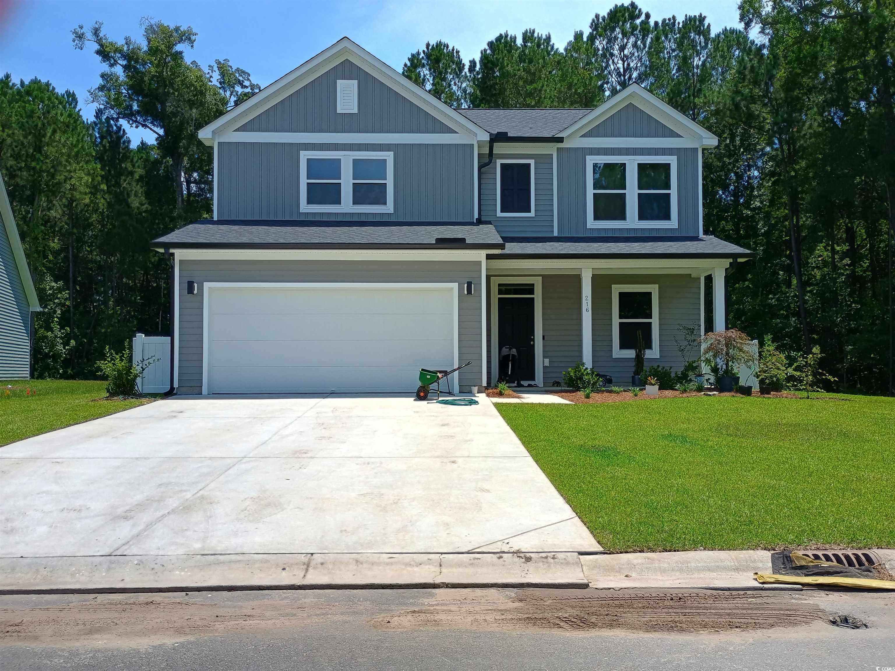 216 Valerio Street Myrtle Beach, SC 29579 - Photo 1 of 2 View of front of property with a front lawn, a garage, concrete driveway, and covered porch