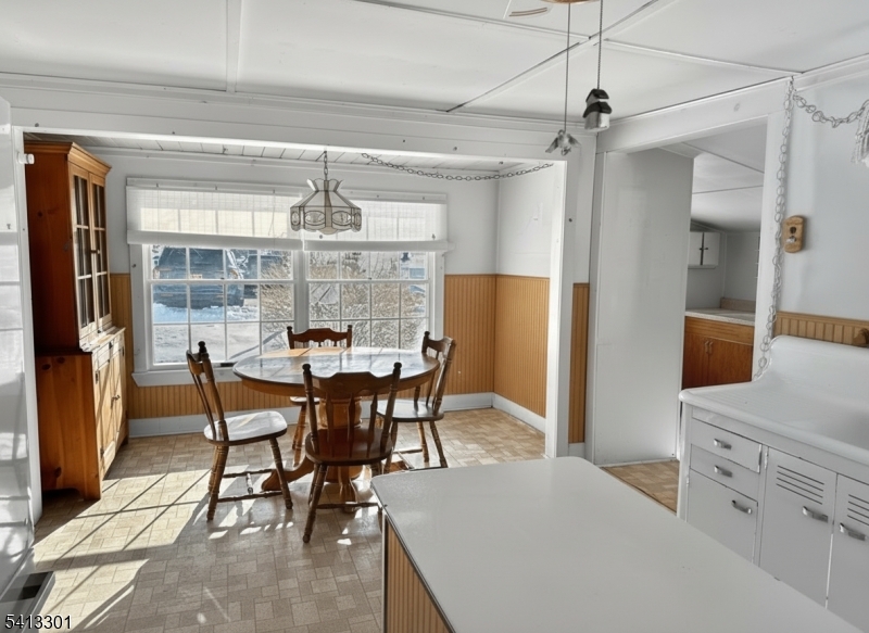 13 Ice Plant Road Lafayette, NJ 07848 - Photo 4 of 19 a view of a dining room with furniture and a chandelier
