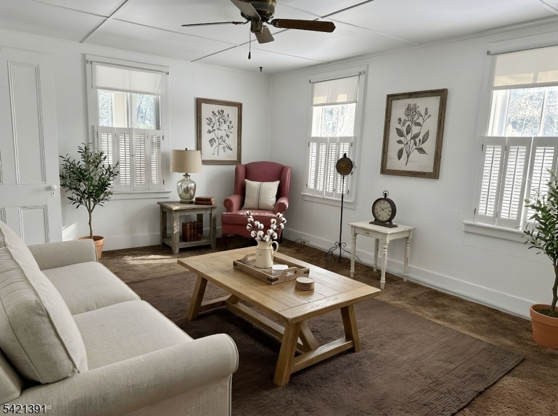 13 Ice Plant Road Lafayette, NJ 07848 - Photo 9 of 19 a living room with furniture a chandelier and a window