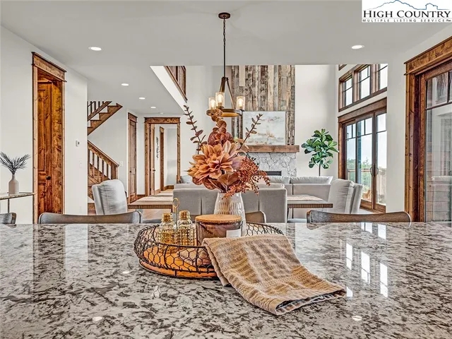 a bathroom with a granite countertop sink a toilet and a mirror