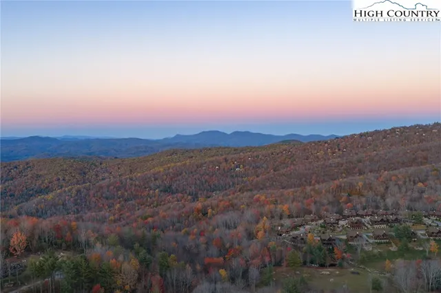a large bedroom with a large bed and a large window