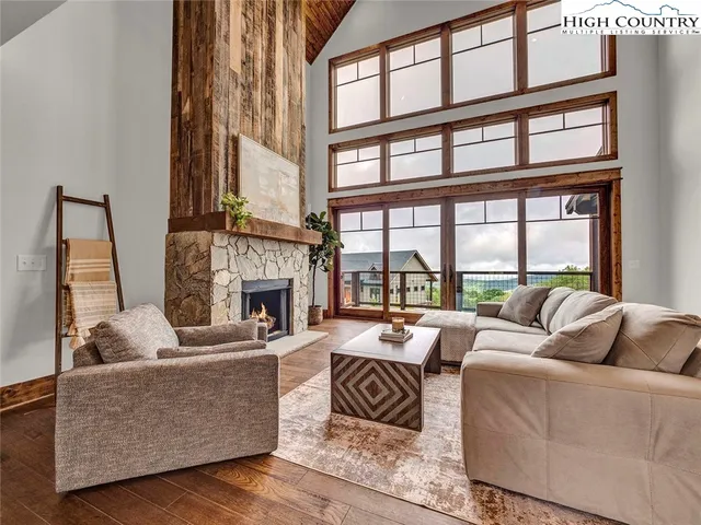 a kitchen with stainless steel appliances granite countertop a stove oven a dining table and chairs with wooden floor