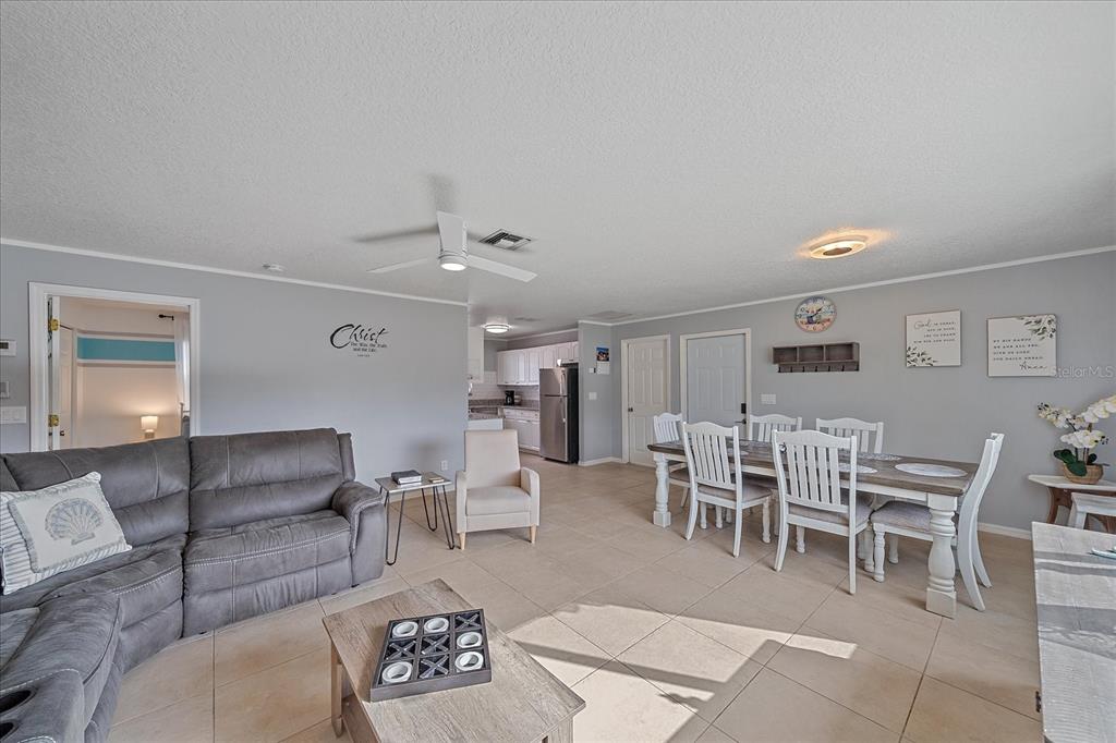 772 Locklear Avenue Sarasota, FL 34237 - Photo 16 of 40 a living room with furniture and a dining table with kitchen view
