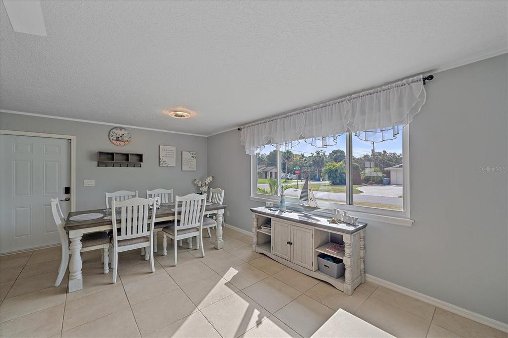 772 Locklear Avenue Sarasota, FL 34237 - Photo 18 of 40 a dining room with a window and chairs