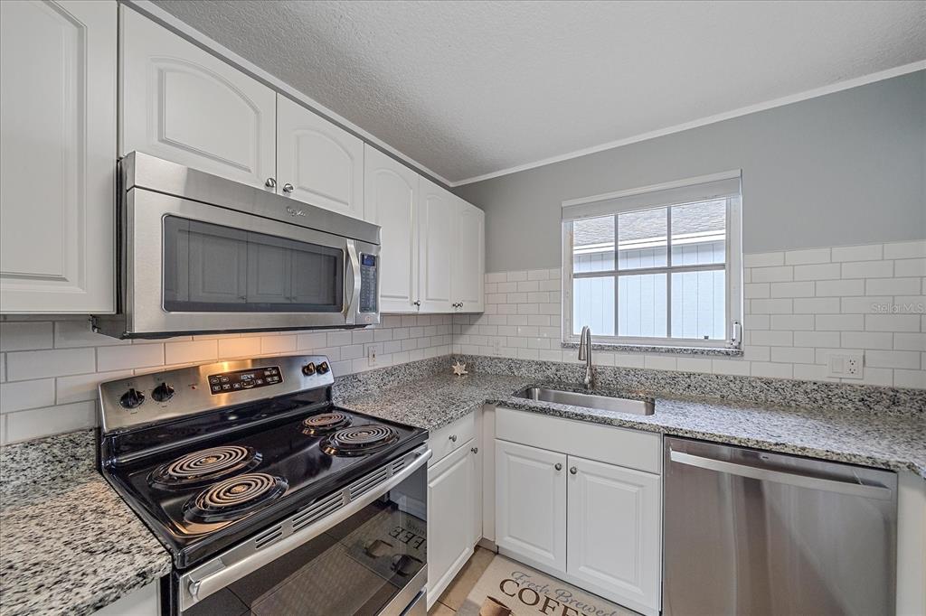 772 Locklear Avenue Sarasota, FL 34237 - Photo 27 of 40 a kitchen with sink stove and microwave
