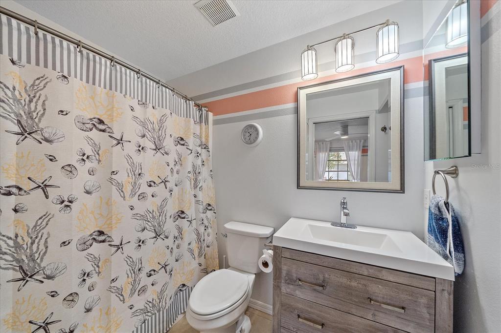 772 Locklear Avenue Sarasota, FL 34237 - Photo 32 of 40 a bathroom with a sink a toilet and shower curtain