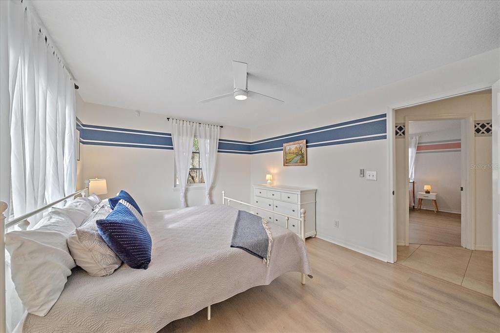 772 Locklear Avenue Sarasota, FL 34237 - Photo 34 of 40 a bedroom with a large bed and a chandelier