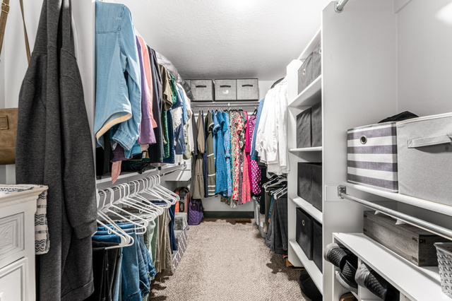 313 Old Maple Road South Weber, UT 84405 - Photo 16 of 35 Walk-in closet featuring extensive built-in shelving, multiple hanging rods, and carpet flooring