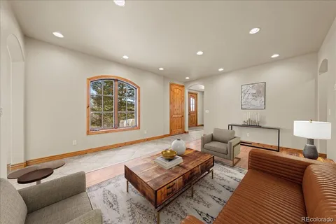 a living room with furniture a rug and a table
