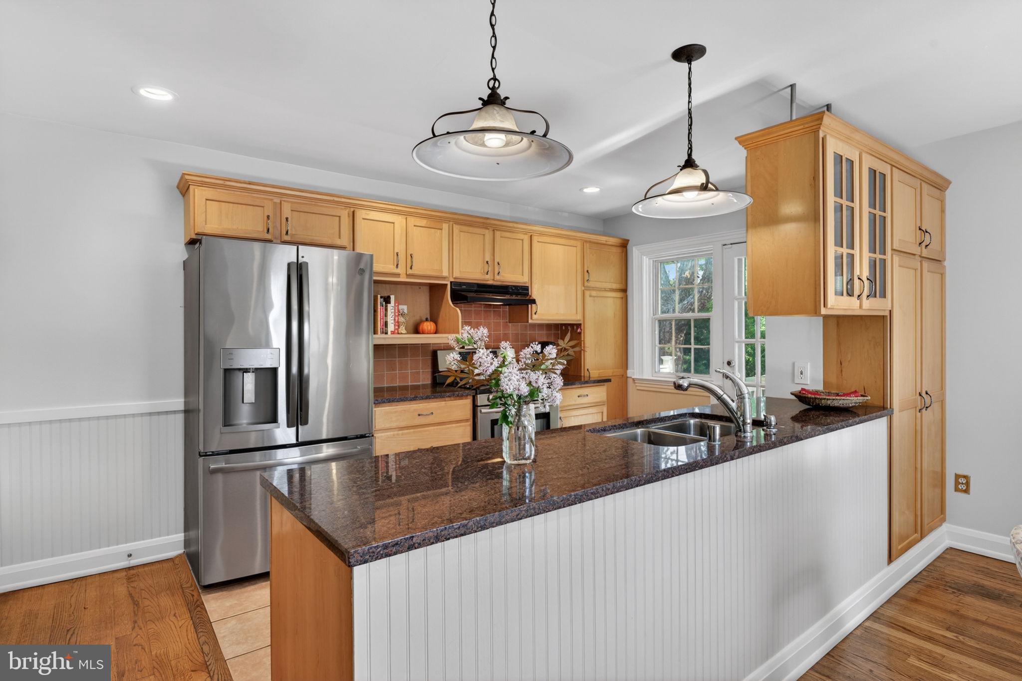 158 Hopkins Road Baltimore, MD 21212 - Photo 18 of 68 a kitchen with stainless steel appliances granite countertop a sink and a refrigerator