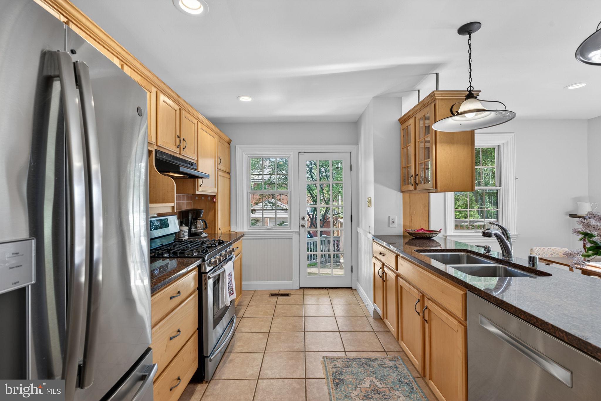 158 Hopkins Road Baltimore, MD 21212 - Photo 19 of 68 a kitchen with granite countertop a refrigerator stove and sink