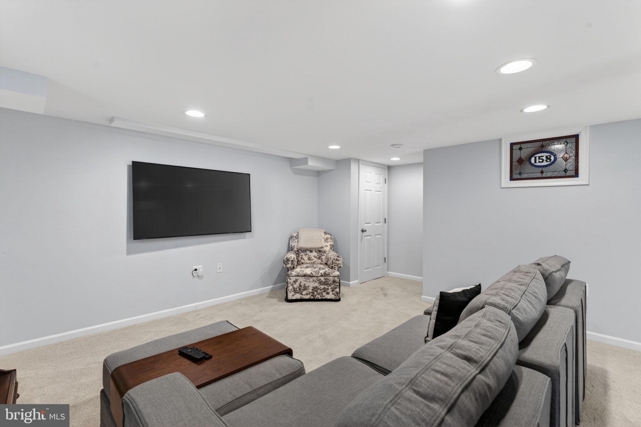158 Hopkins Road Baltimore, MD 21212 - Photo 38 of 68 a living room with furniture and a flat screen tv