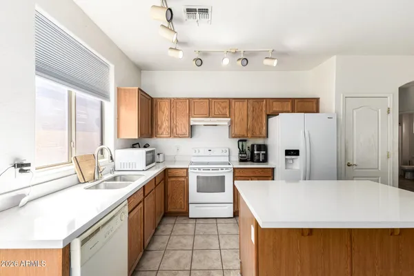 a kitchen with appliances a sink and cabinets