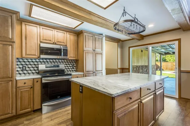 a kitchen with a stove a sink and a refrigerator
