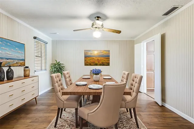 a dining room with furniture a chandelier and wooden floor