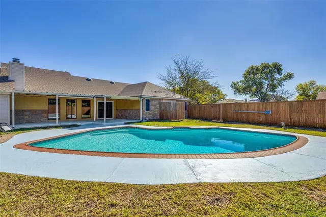 a view of swimming pool with a yard and a outdoor seating