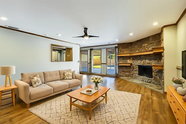 a living room with furniture and a fireplace