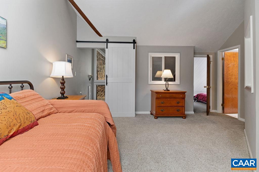 453 3 Ridges Roseland, VA 22967 - Photo 17 of 21 a bedroom with a bed and a chandelier