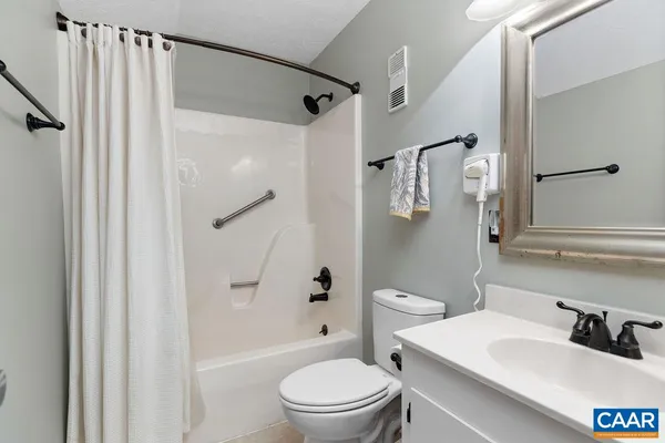 a bedroom with a bed and a mirror