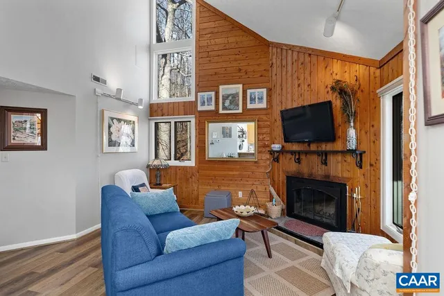 a living room with fireplace furniture and a flat screen tv