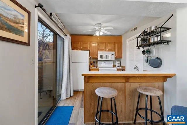 a kitchen with stainless steel appliances a refrigerator and a stove top oven