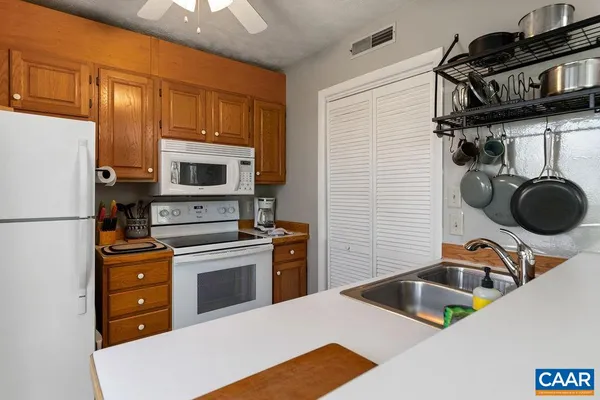 a kitchen with a refrigerator and a sink