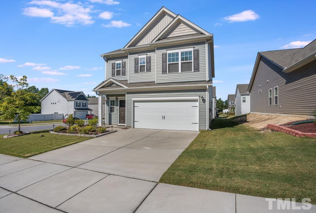 6801 Resting Grove Road Raleigh, NC 27610 - Photo 2 of 28 a front view of a house with garden