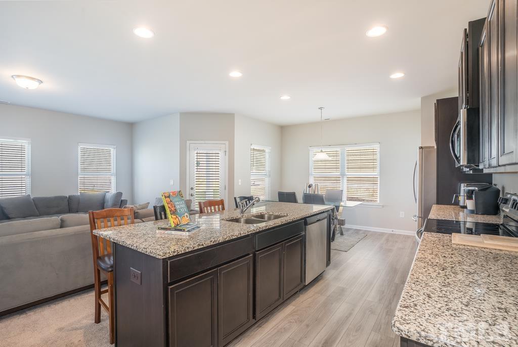 6801 Resting Grove Road Raleigh, NC 27610 - Photo 13 of 28 a view of living room with granite countertop furniture and fireplace