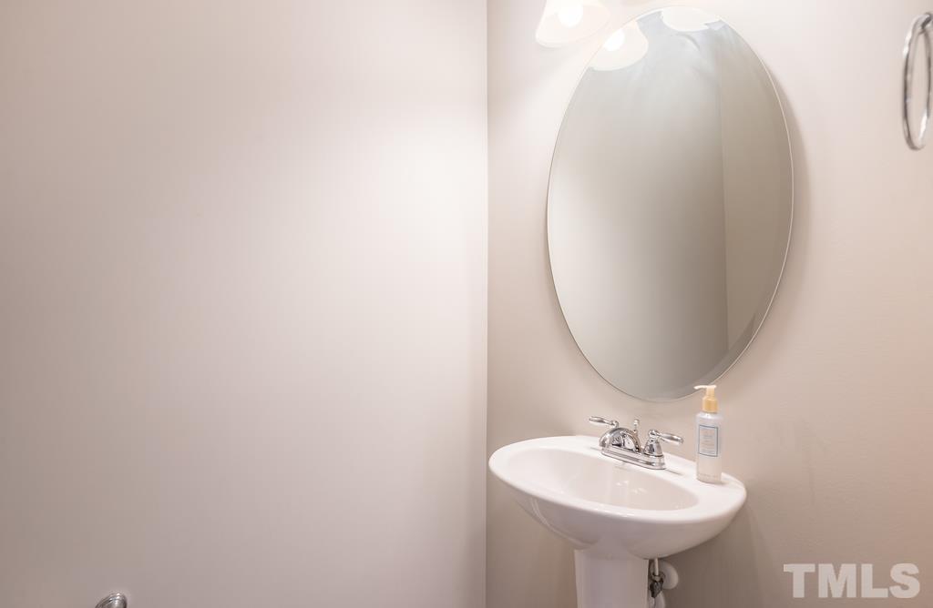 6801 Resting Grove Road Raleigh, NC 27610 - Photo 14 of 28 a bathroom with a sink and a mirror